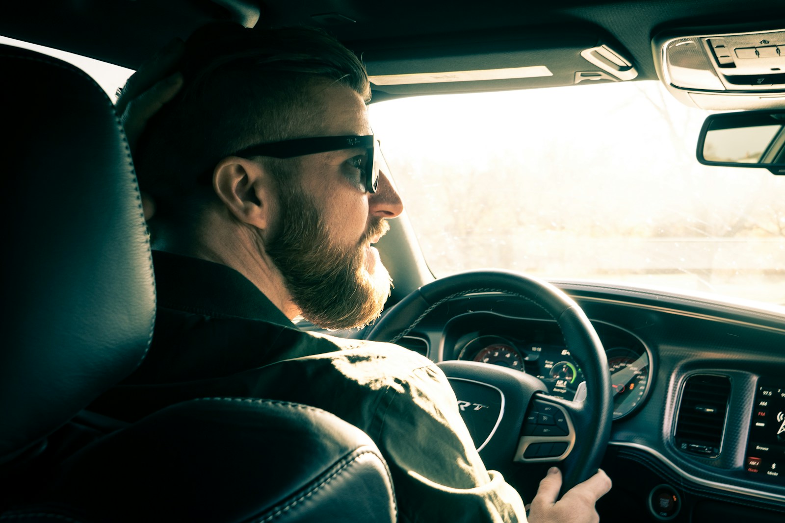 man in black jacket driving car, sr-22